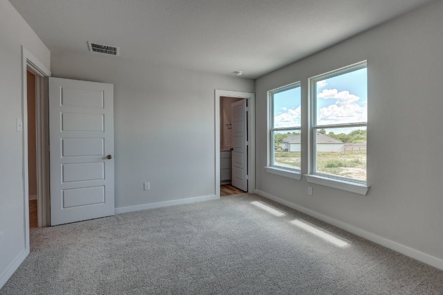 A room with white walls and a window.
