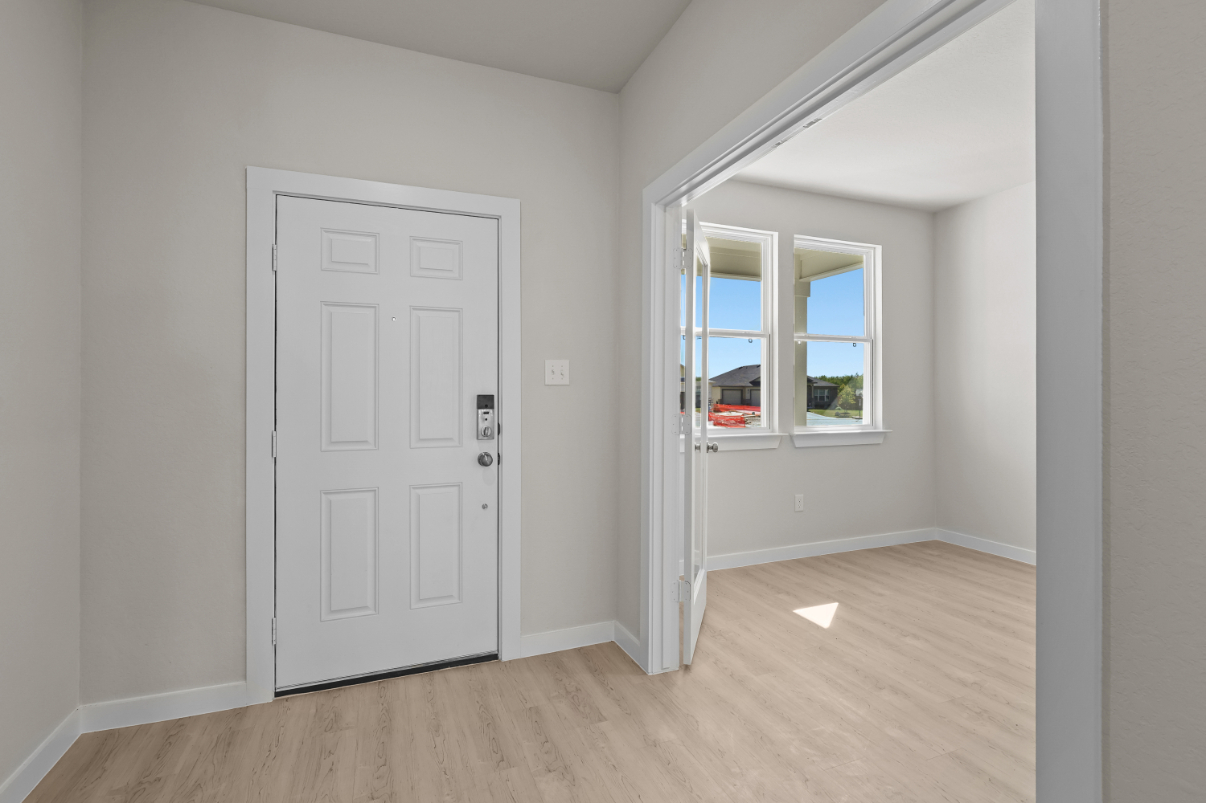 A room with a white door and a window.