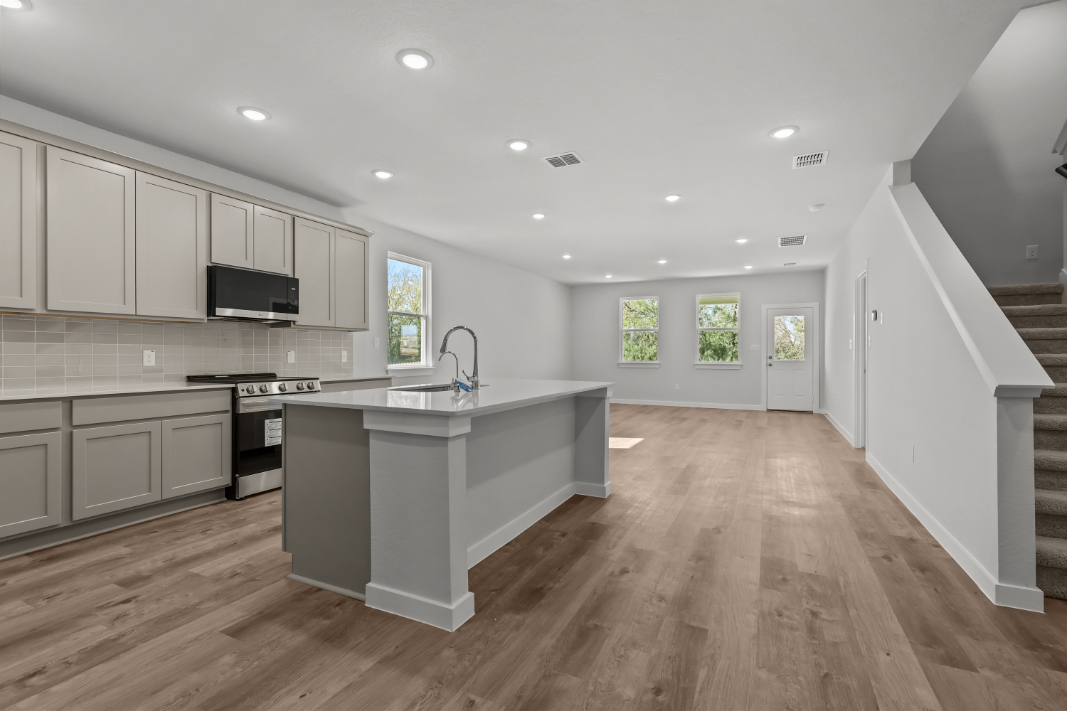 A kitchen with white cabinets.