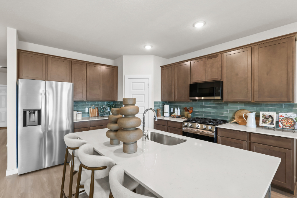 A kitchen with a table and chairs.