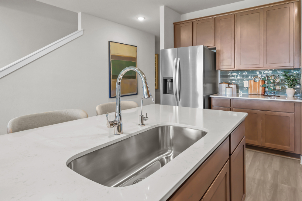A kitchen with a stainless steel sink.