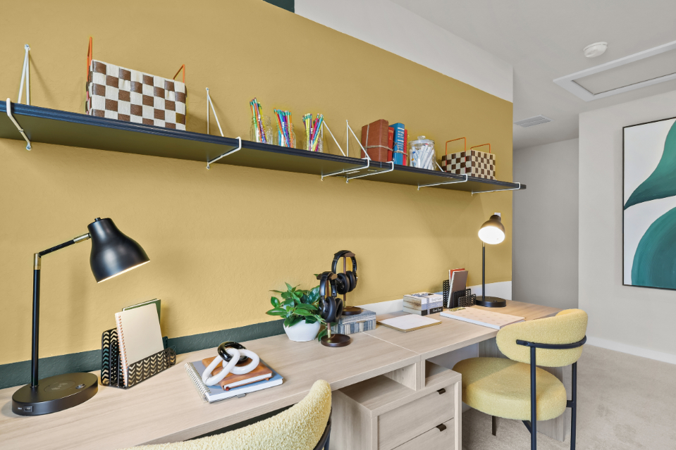 A desk with a lamp and shelves.