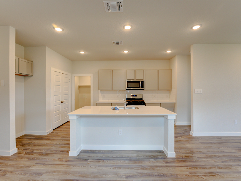 A kitchen with white cabinets.