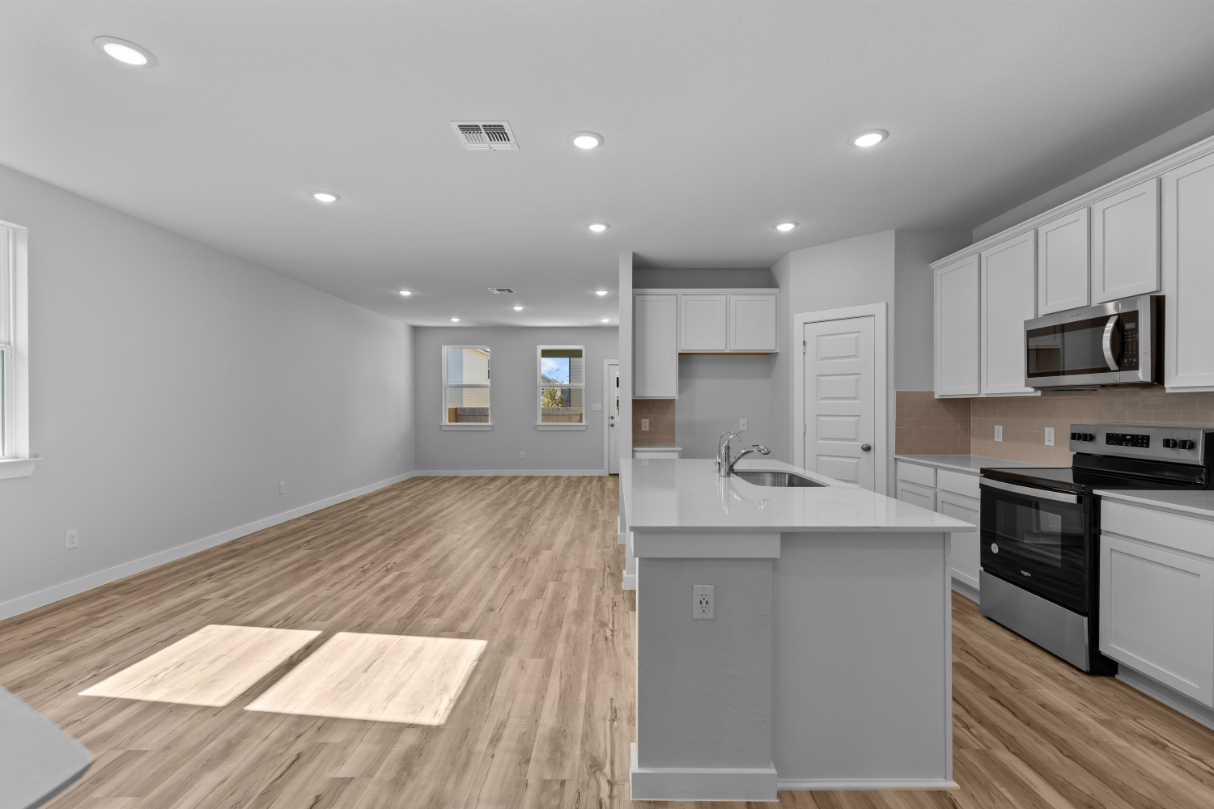 A kitchen with white cabinets.