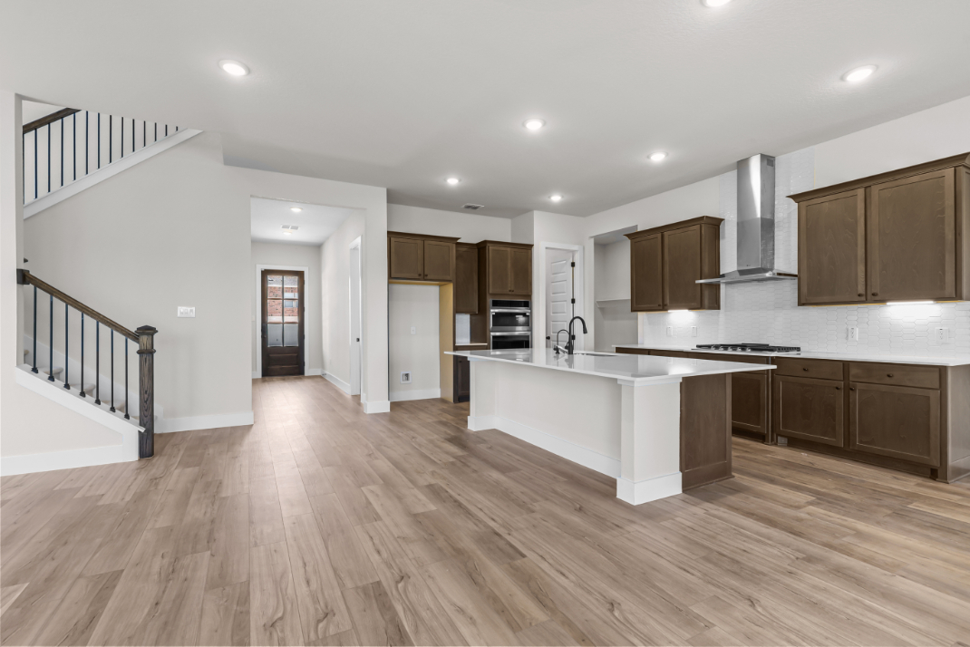 A kitchen with wooden floors.