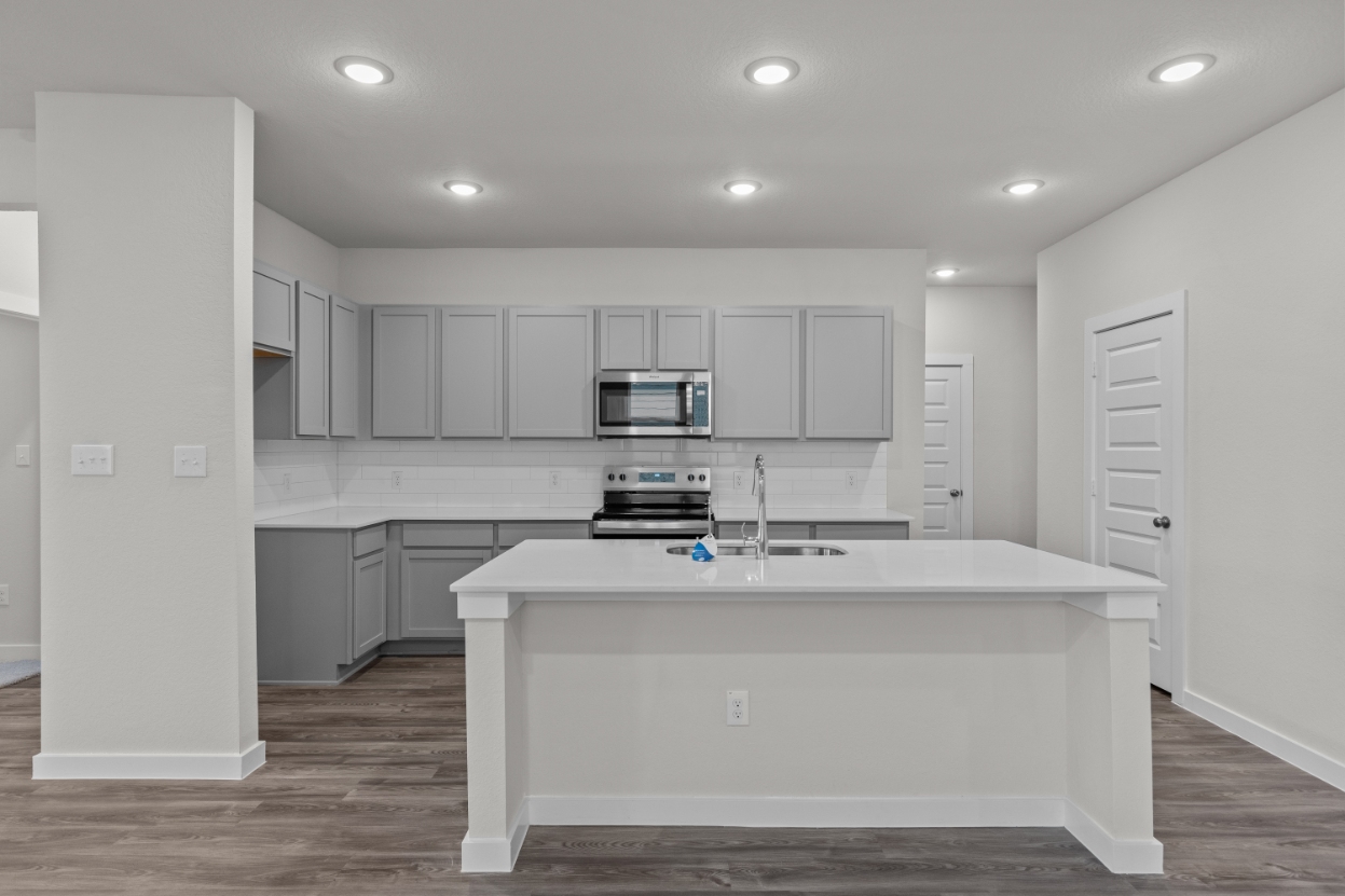 A kitchen with white cabinets.