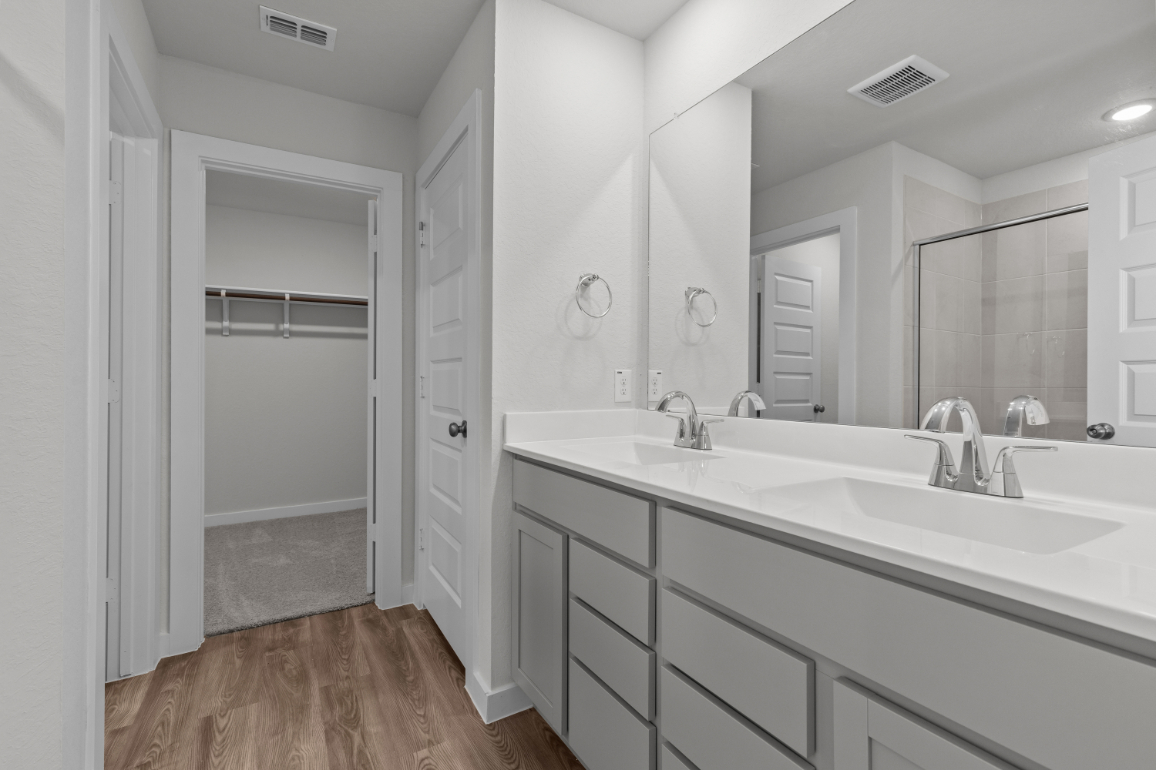 A bathroom with a large mirror.