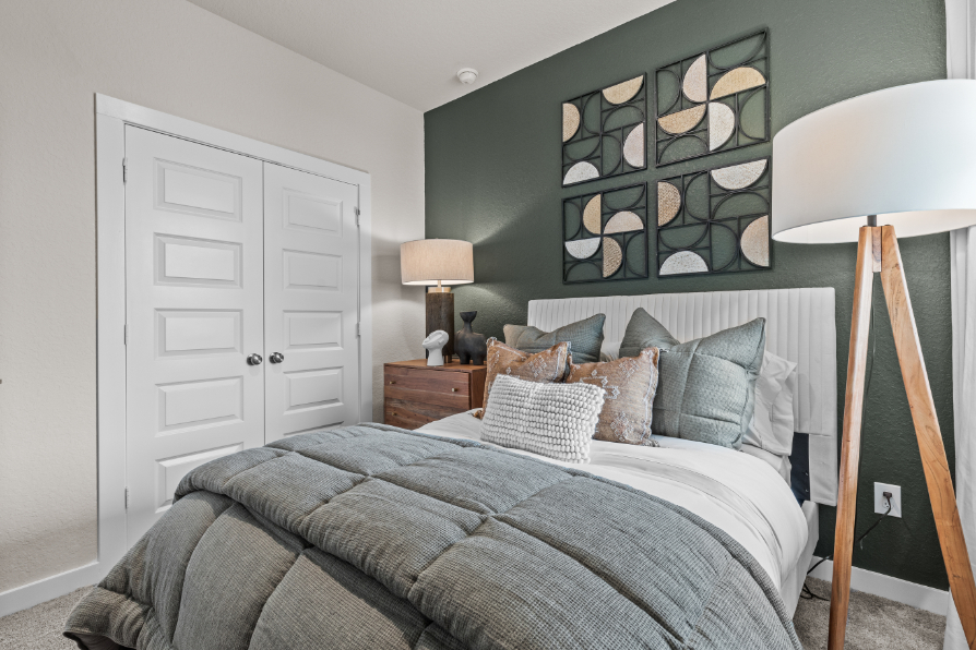 A bed with pillows and lamps.