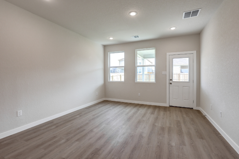 A room with a wood floor and white walls.