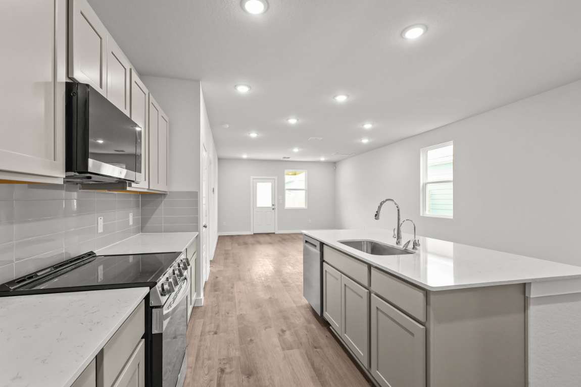 A kitchen with white cabinets.