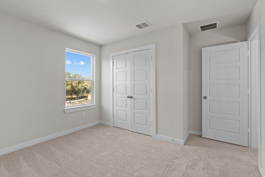 A room with white doors and a window.