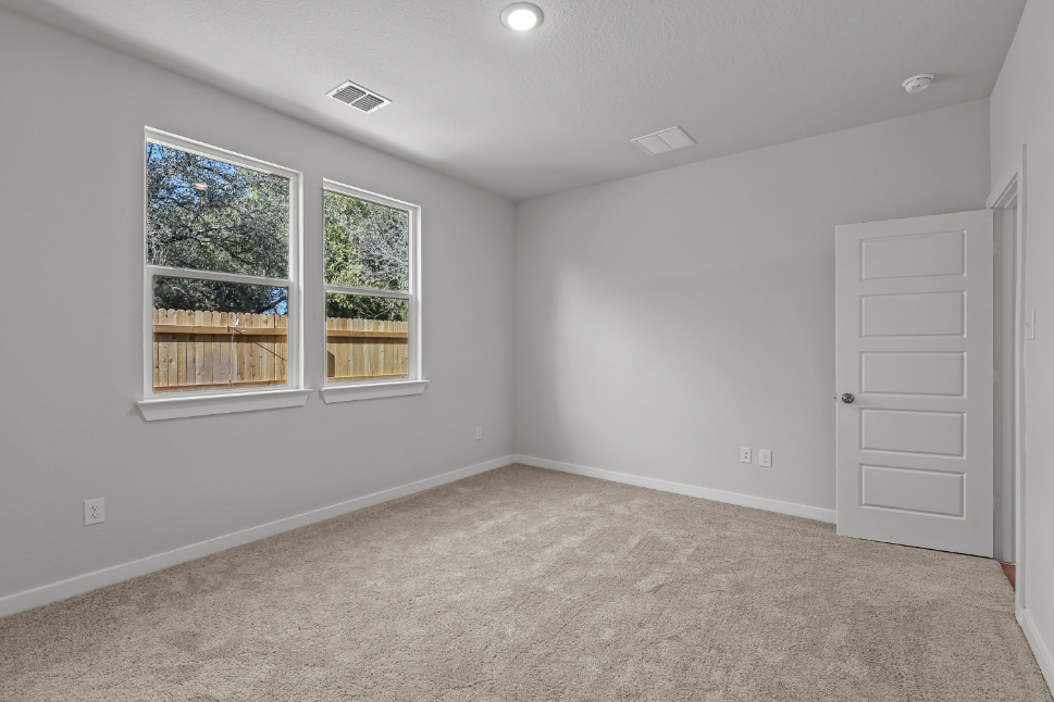 A room with a white door and windows.