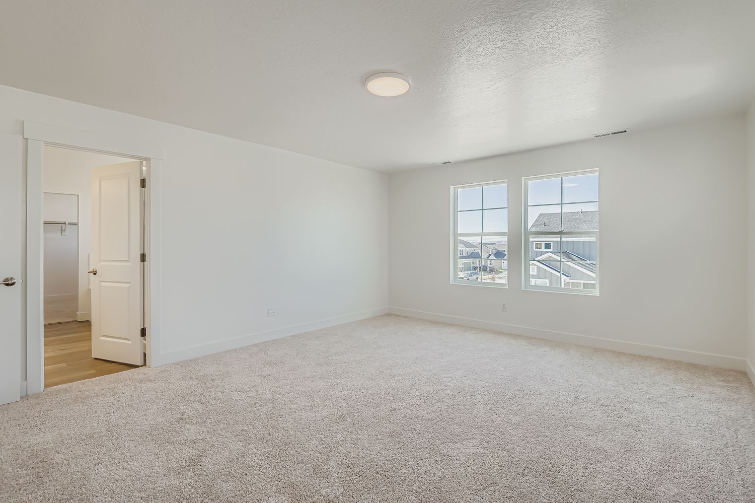 A room with white walls and a window.