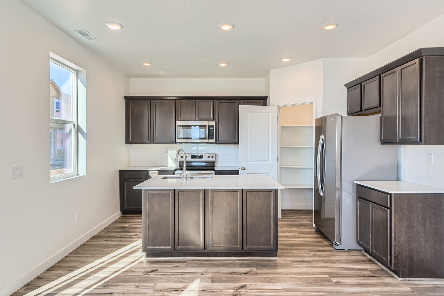A kitchen with black cabinets.