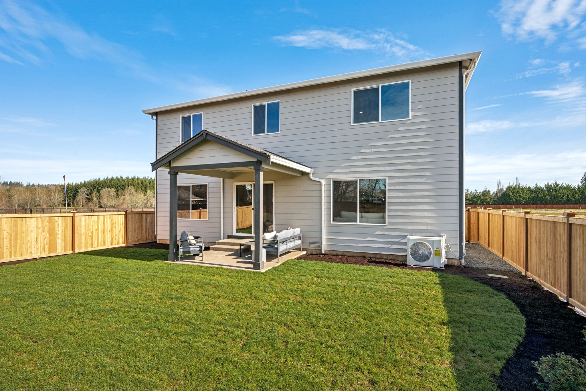 A house with a fence and grass.