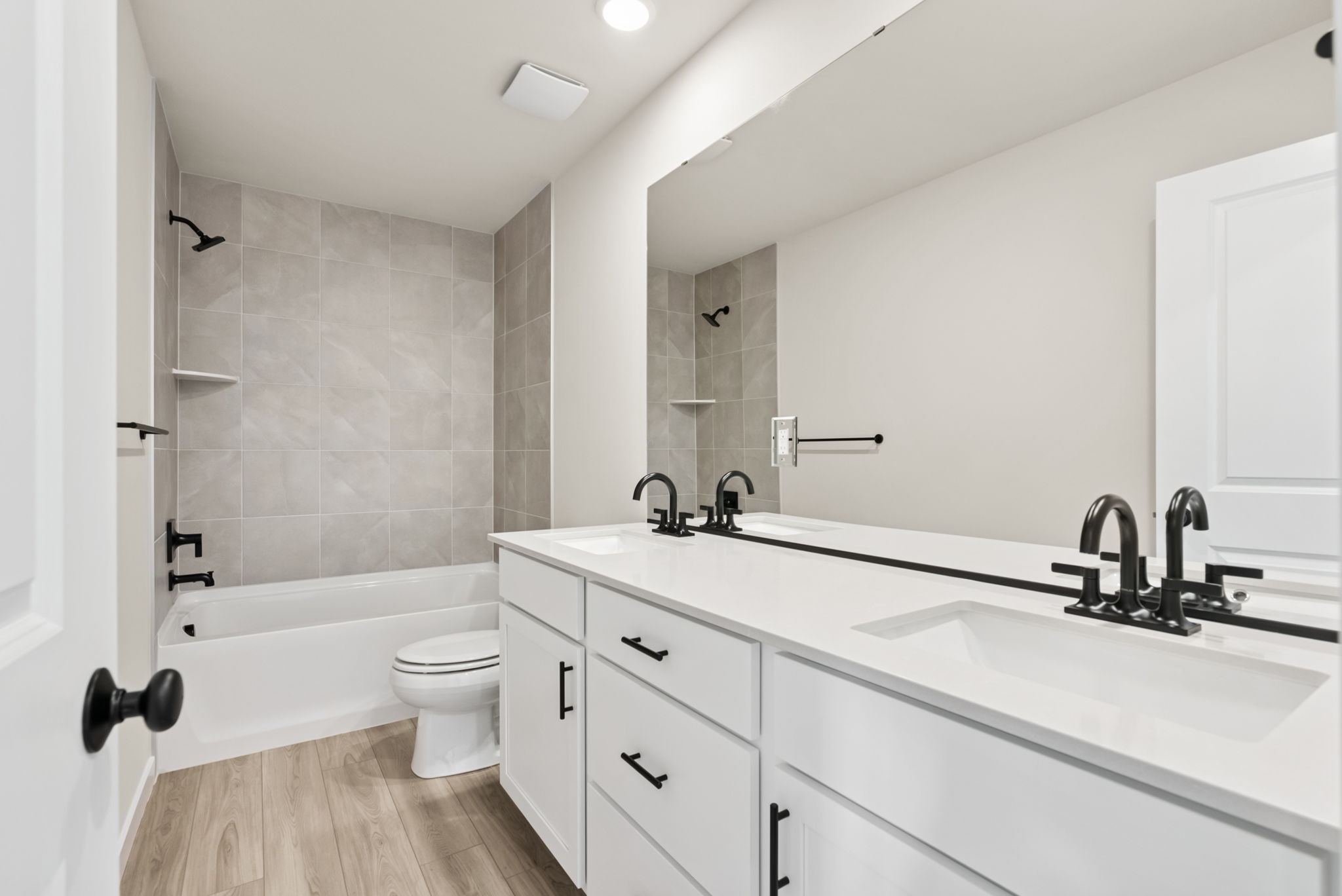 A bathroom with a tub sink and toilet.