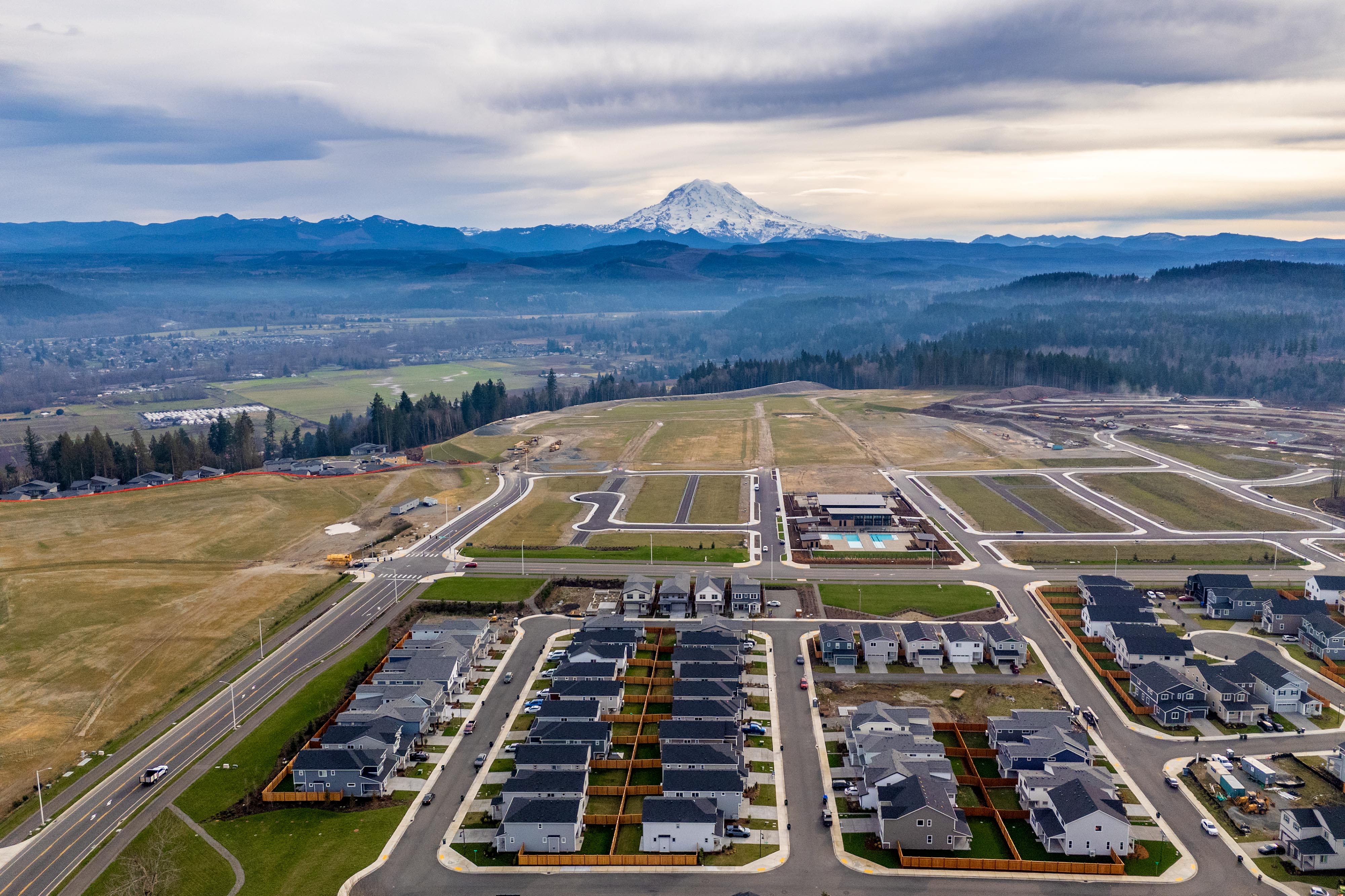 A large parking lot with a mountain in the background.