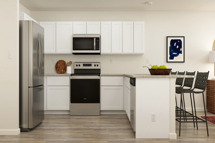 A kitchen with white cabinets.