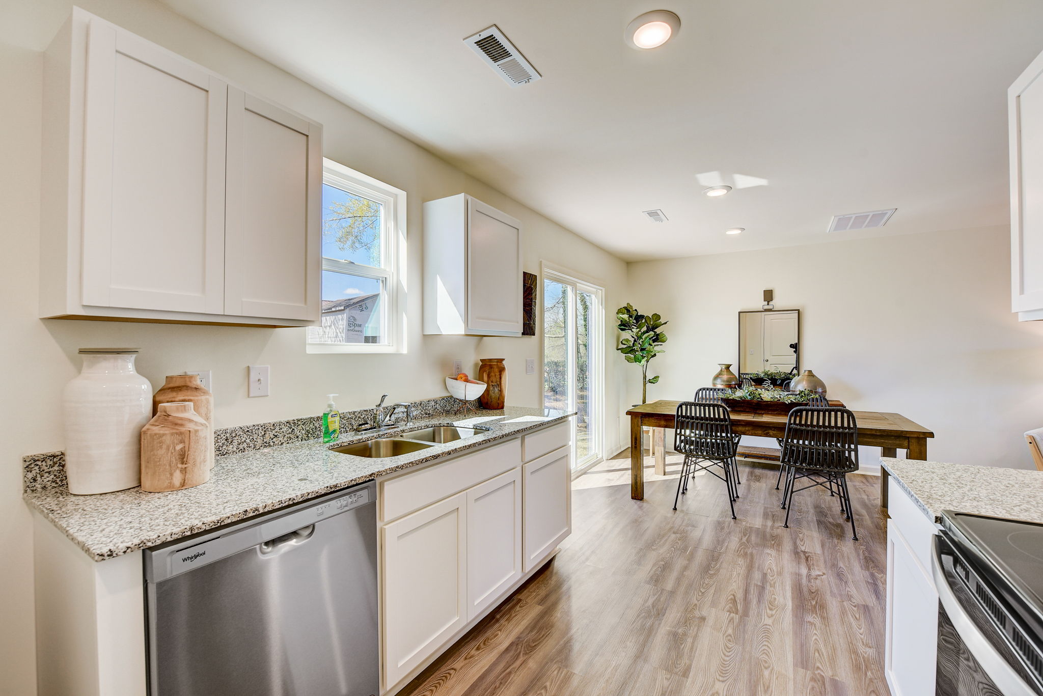 A kitchen with white cabinets.