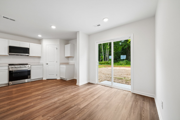 A kitchen with a wood floor.