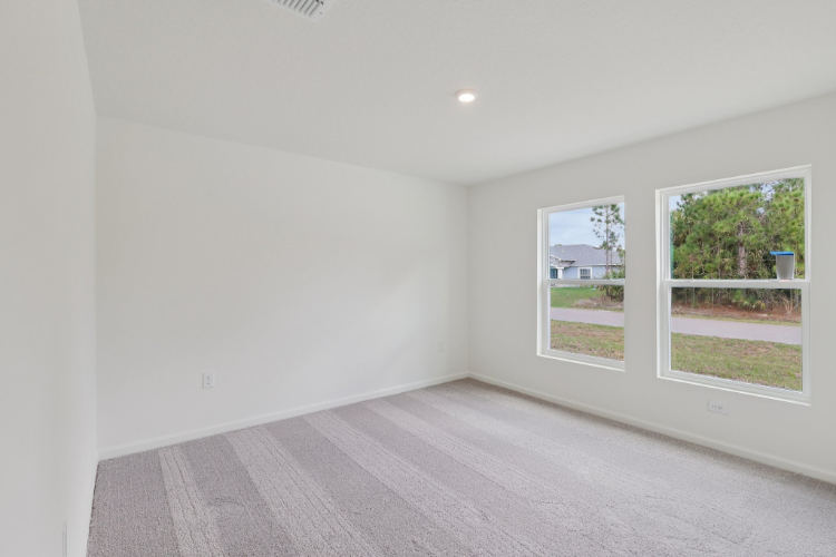 A room with a wood floor and windows.