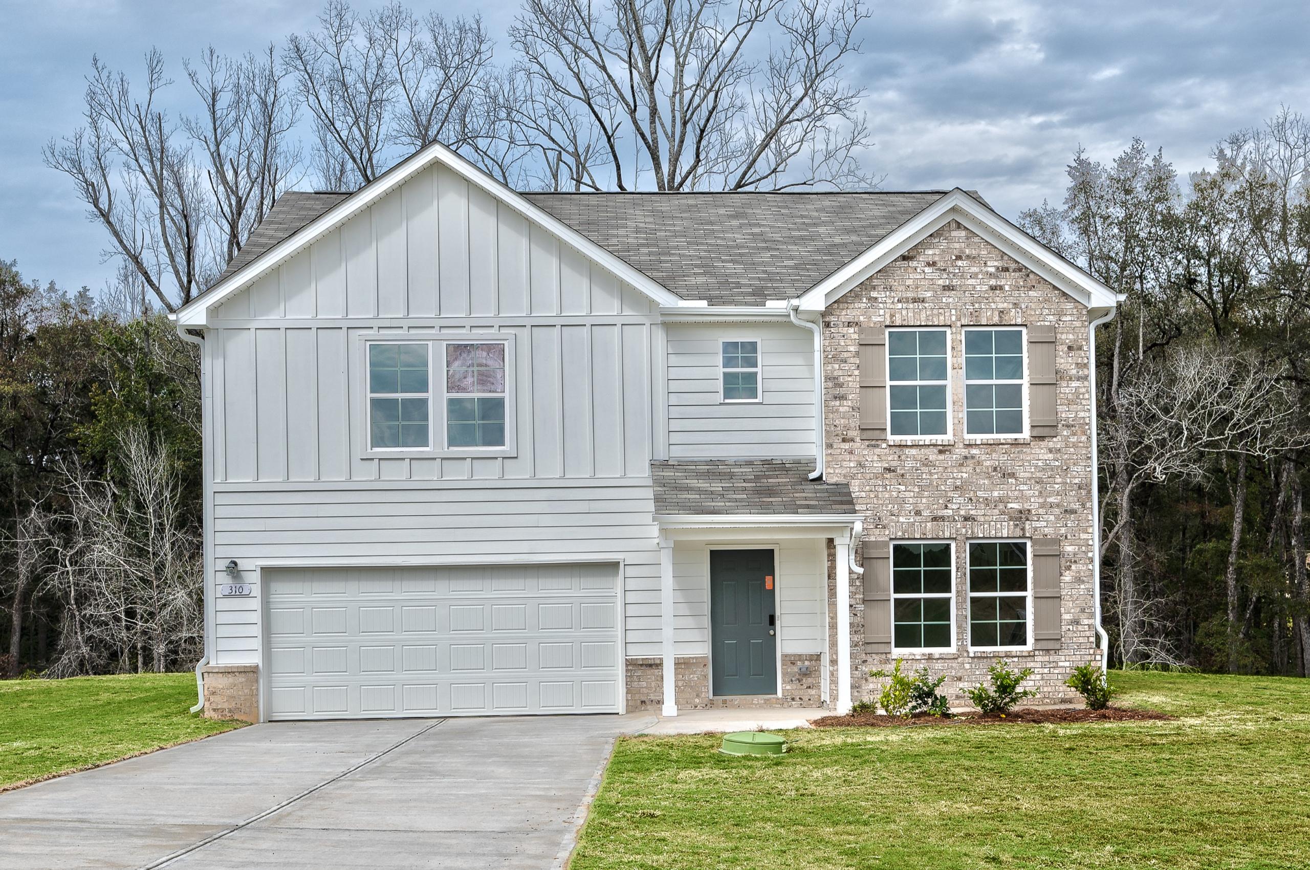 A grey house with a garage.