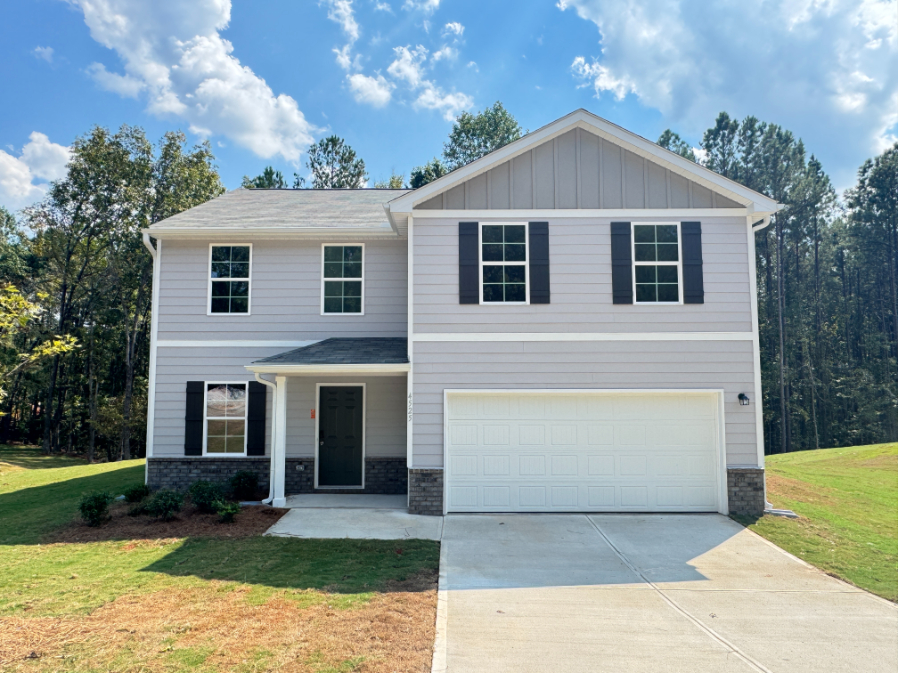 A white house with a garage.