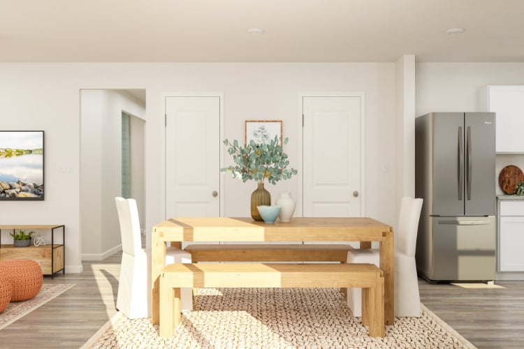 A living room with a table and chairs.