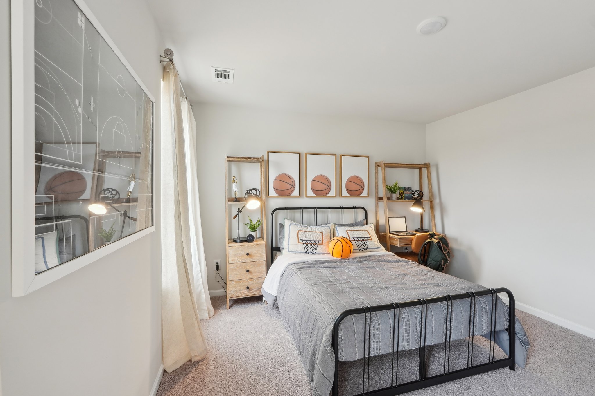 A bedroom with a bed and a mirror.