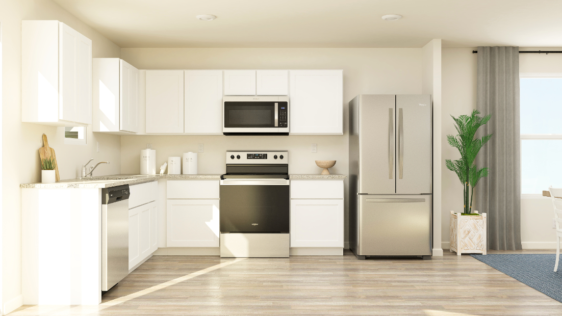 A kitchen with white cabinets.