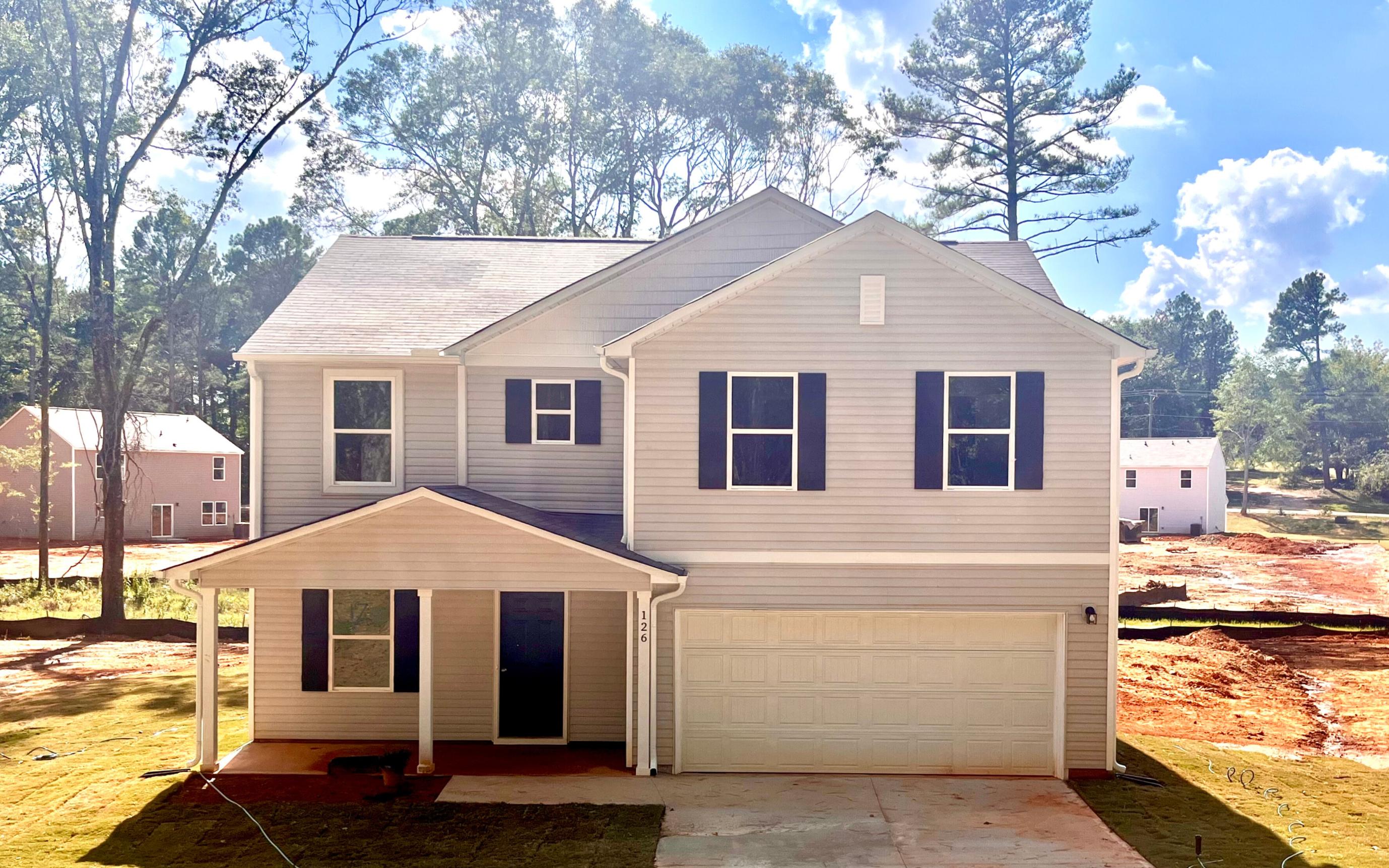 A white house with a garage.