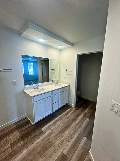 A bathroom with a wood floor.