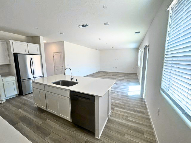 A kitchen with white cabinets.