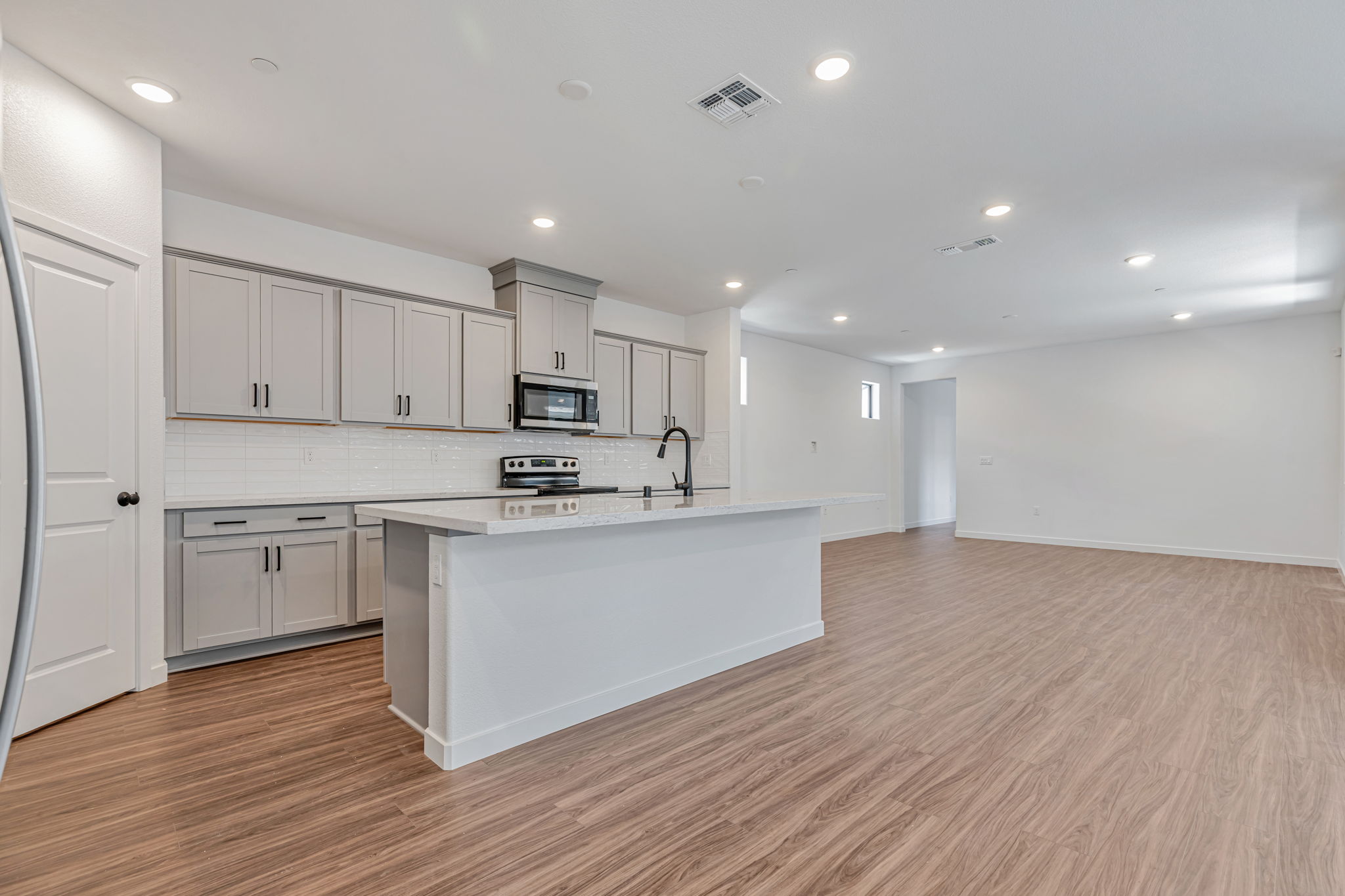 A kitchen with white cabinets.